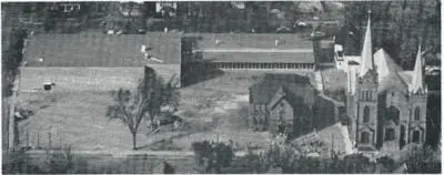 1951—A unique aeriel view of the original St. Joseph School building (just right of the center), and the original St. Joseph Church (far right), while the new school was being constructed in the background.